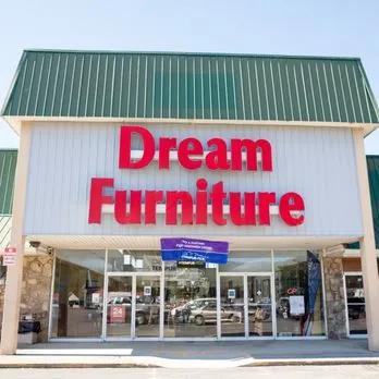 A store front of a furniture store with the words " dream furniture ".