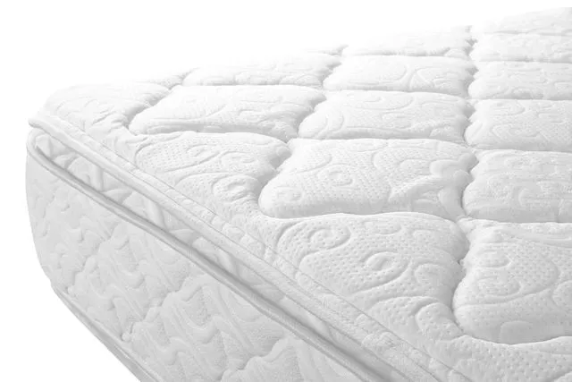 A close up of the bottom part of an unmade bed.