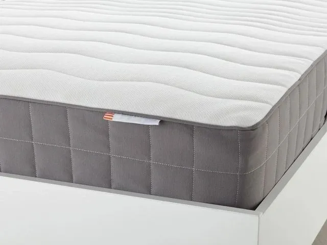 A mattress with an open pocket on the side.
