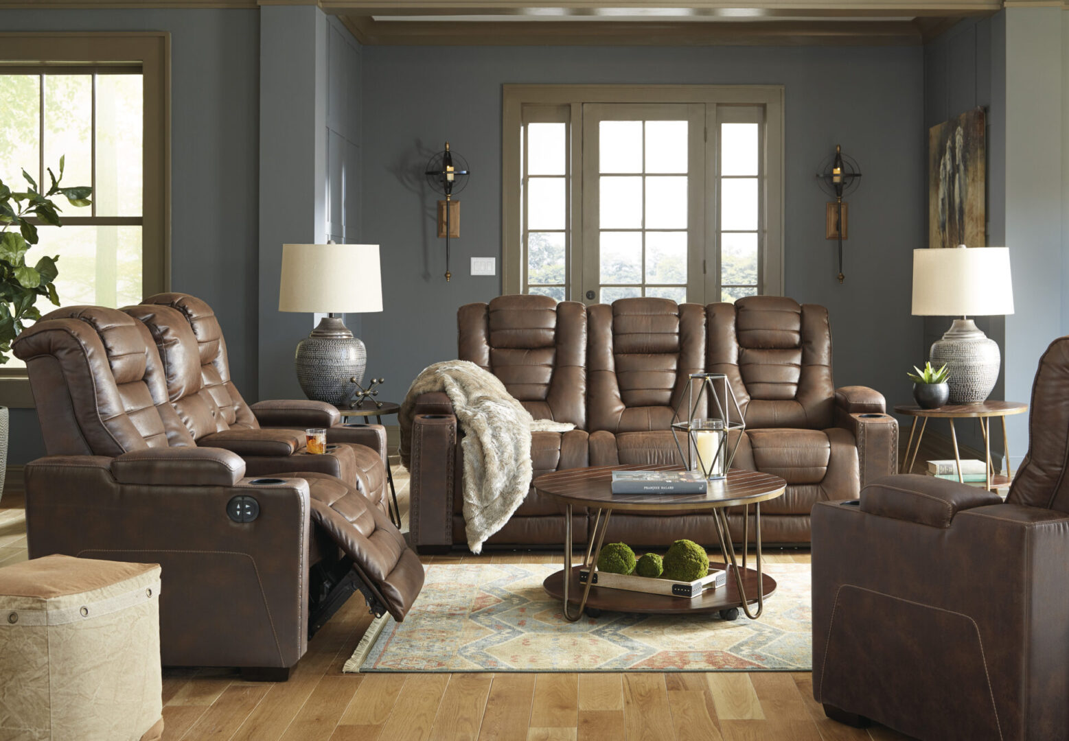 A living room with two couches and a recliner.