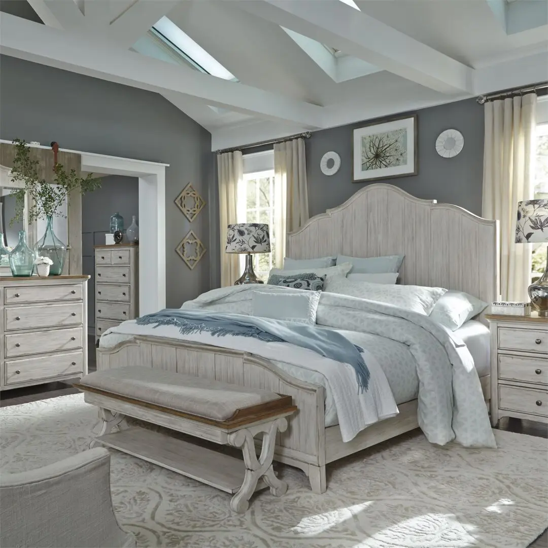A bedroom with a bed, dresser and nightstand.