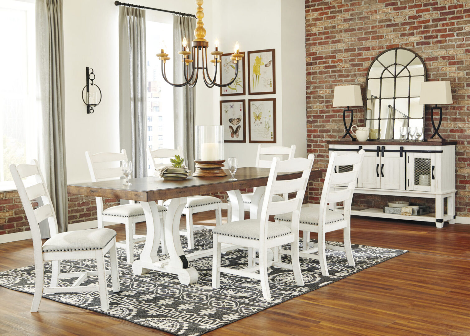 A dining room with white chairs and a table