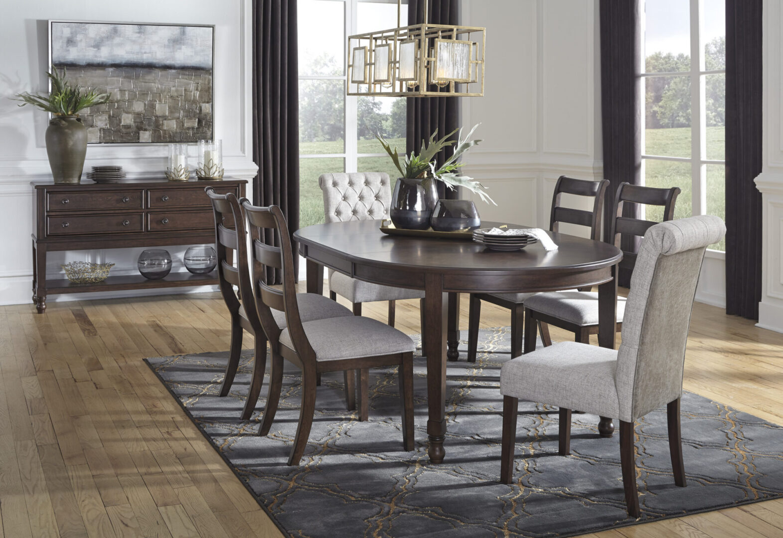 A dining room table and chairs in the center of a living room.