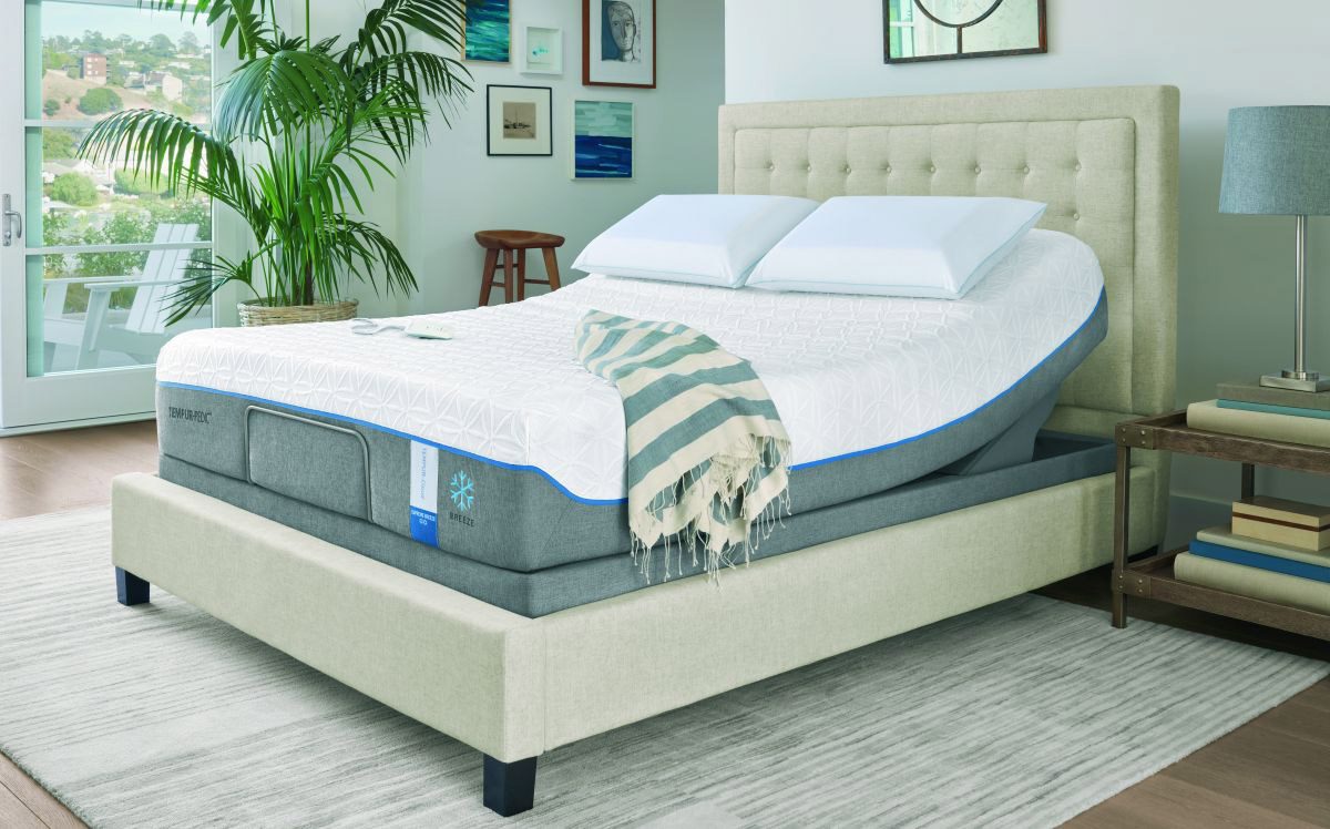 A bed with a mattress and pillows on it